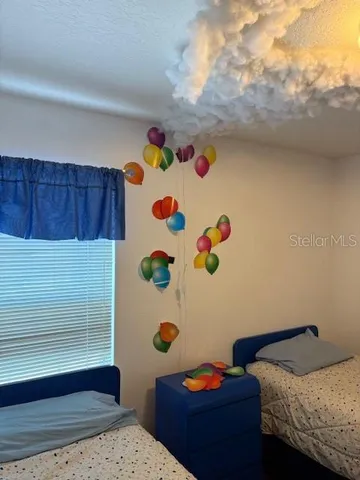 a bedroom with a bed and a chandelier