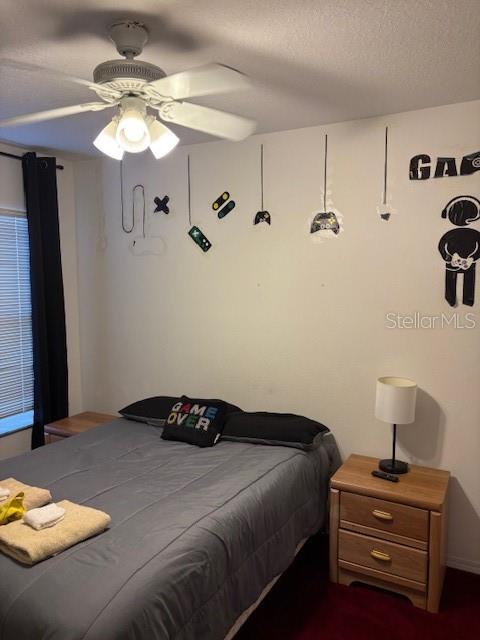 8410 Secret Key Cove Kissimmee, FL 34747 - Photo 37 of 41 a bedroom with a bed and a chandelier