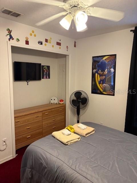 8410 Secret Key Cove Kissimmee, FL 34747 - Photo 38 of 41 a bedroom with a bed and a chandelier