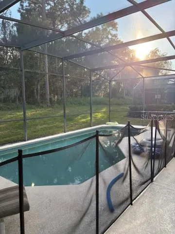 a view of swimming pool with a patio and a backyard