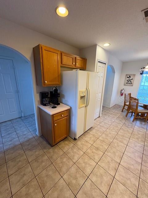 8410 Secret Key Cove Kissimmee, FL 34747 - Photo 6 of 41 a kitchen with a sink a refrigerator and wooden cabinets