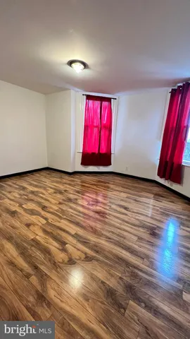a view of a room with wooden floor and window