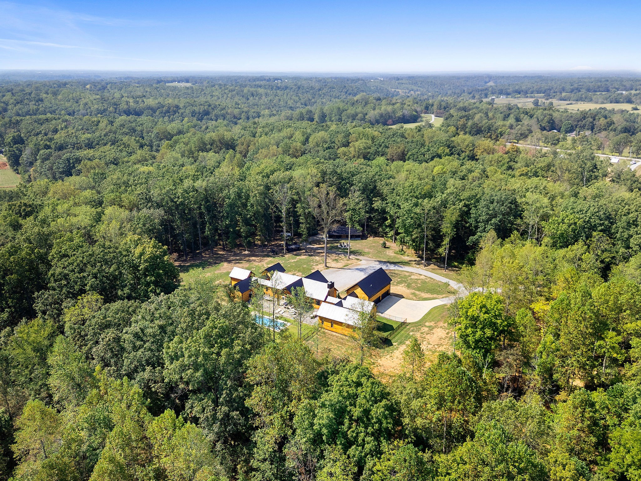 7638 Younger Creek Road Primm Springs, TN 38476 - Photo 88 of 95 an aerial view of residential houses with yard and swimming pool