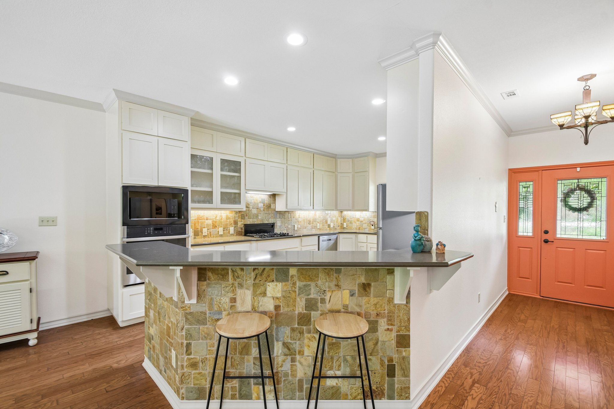 307 West 4th Street Elgin, TX 78621 - Photo 11 of 40 Kitchen with white cabinetry, stone backsplash, and recessed lighting