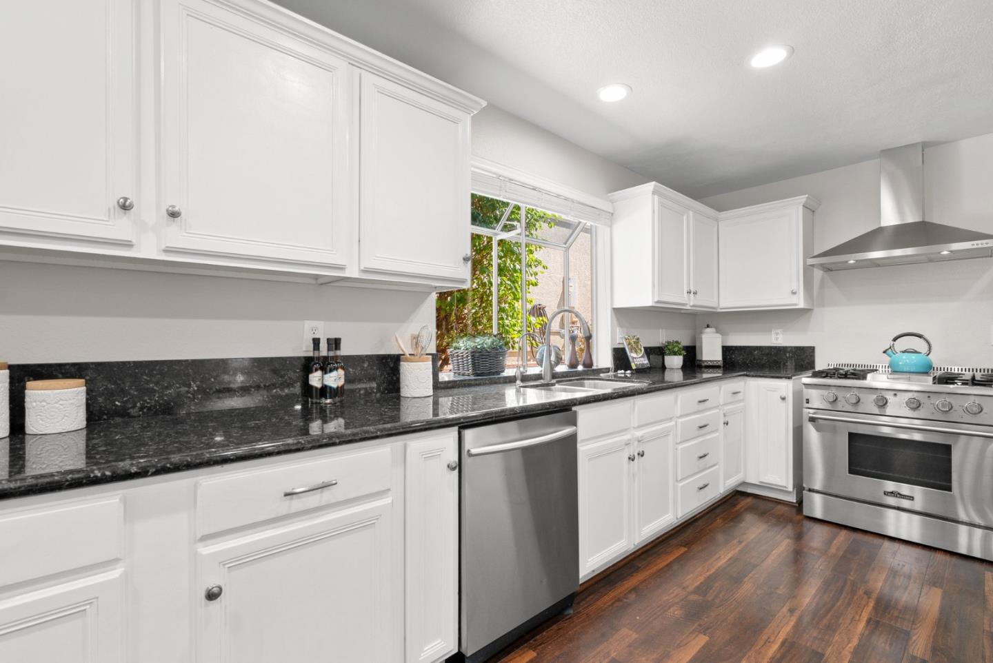 205 Sidesaddle Circle Scotts Valley, CA 95066 - Photo 14 of 57 a kitchen with granite countertop white cabinets and white stainless steel appliances