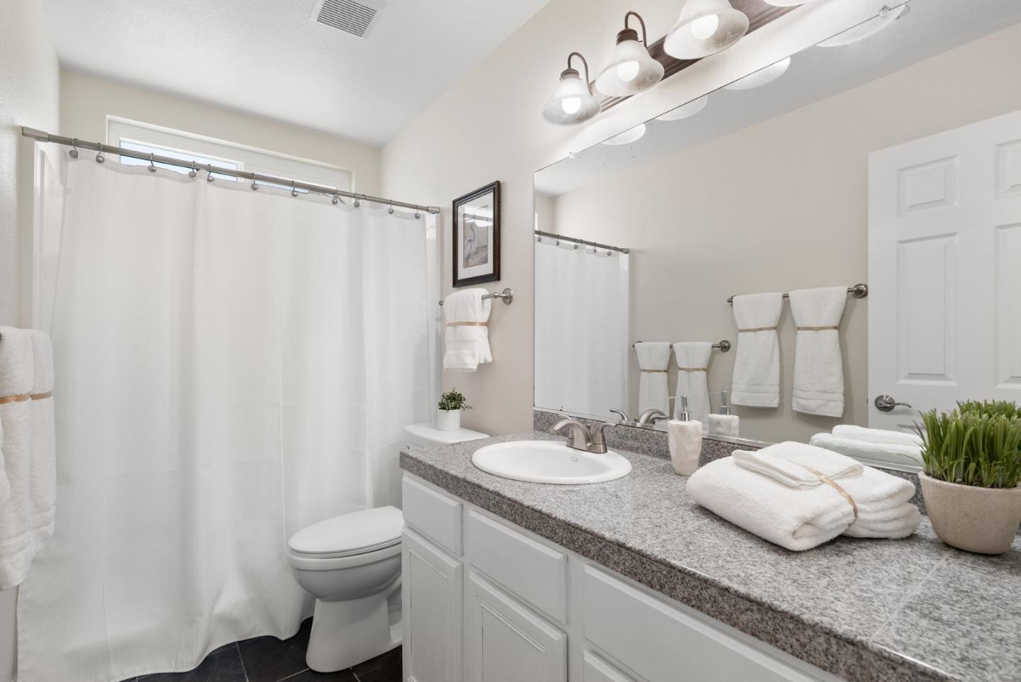 205 Sidesaddle Circle Scotts Valley, CA 95066 - Photo 38 of 57 a bathroom with a granite countertop sink a toilet and a mirror