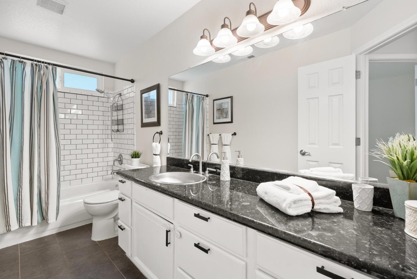 205 Sidesaddle Circle Scotts Valley, CA 95066 - Photo 41 of 57 a bathroom with a granite countertop sink a toilet and mirror
