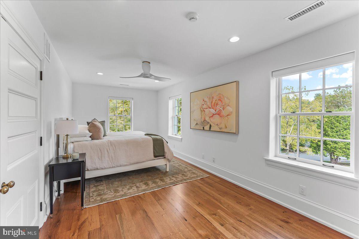 80 Heyburn Road Chadds Ford, PA 19317 - Photo 56 of 76 a spacious bedroom with a large bed and a wooden floor