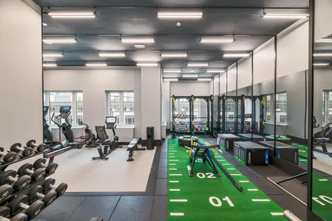 a living room with lots of furniture a chandelier a rug kitchen view and a chandelier