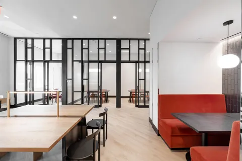 a living room with furniture and floor to ceiling windows