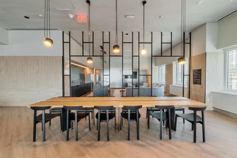 a large kitchen with a table and chairs