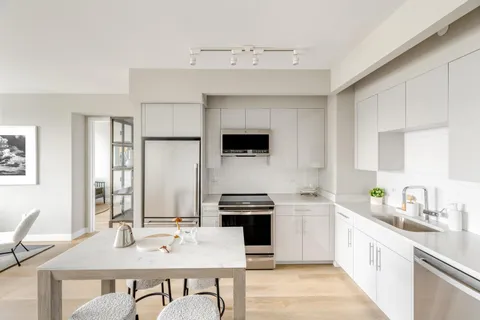 a kitchen with a stove a sink and a refrigerator