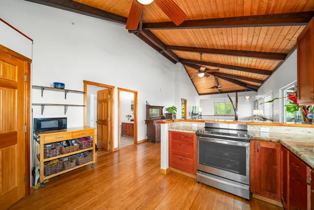 a kitchen with stainless steel appliances granite countertop a stove sink and cabinets