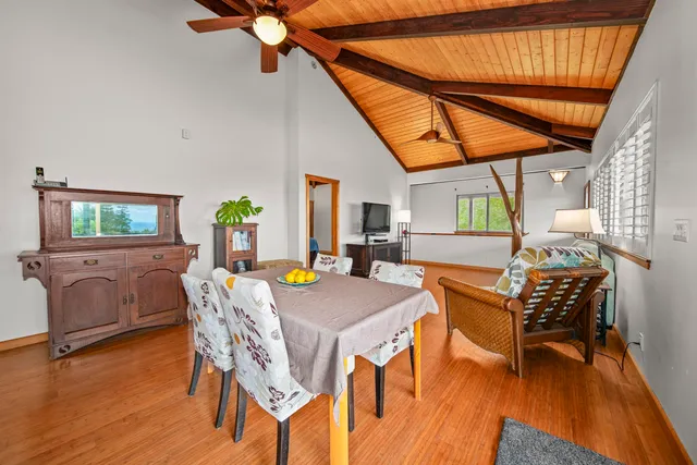 a dining room with furniture and wooden floor