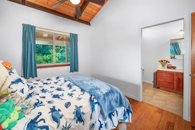 a spacious bathroom with a granite countertop toilet a sink and a bathtub