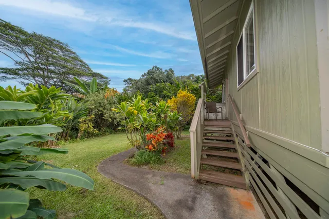 a view of a pathway of a house with a yard