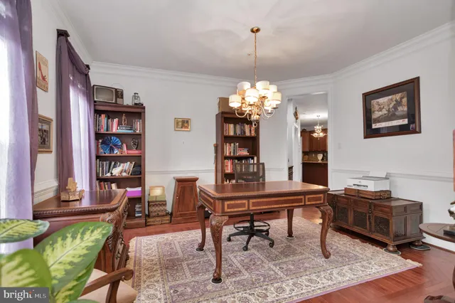 a view of a a dining room with furniture window and wooden floor