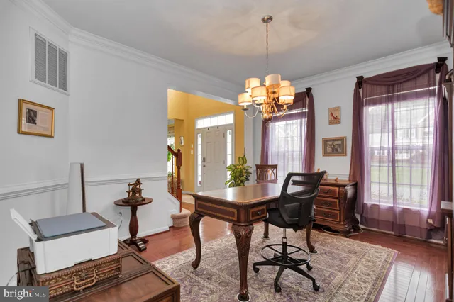 a kitchen with stainless steel appliances granite countertop a stove top oven a sink dishwasher a dining table and chairs with wooden floor