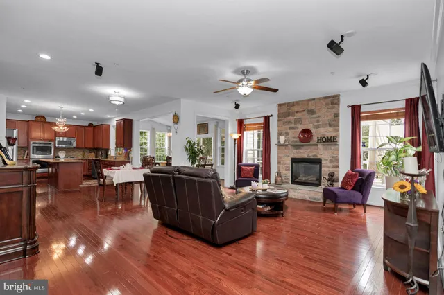 a kitchen with stainless steel appliances granite countertop wooden cabinets and a stove top oven