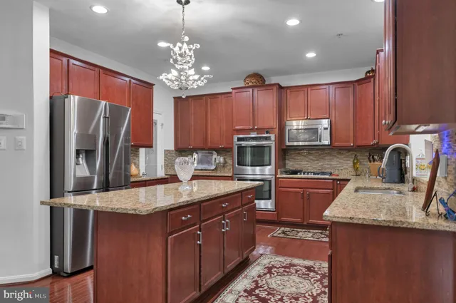 a view of a hallway with wooden floor and windows