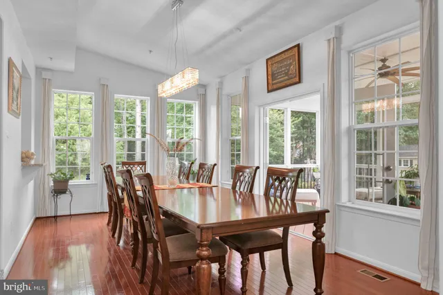 a view of a livingroom with furniture a fireplace window and wooden floor