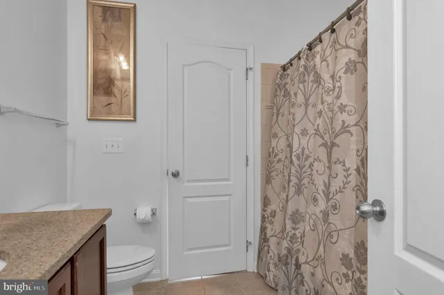 a room with pool table and paintings on the wall