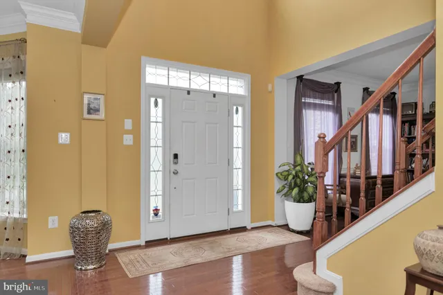 a view of an entryway with wooden floor and door