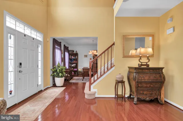a living room with furniture and a flat screen tv with wooden floor