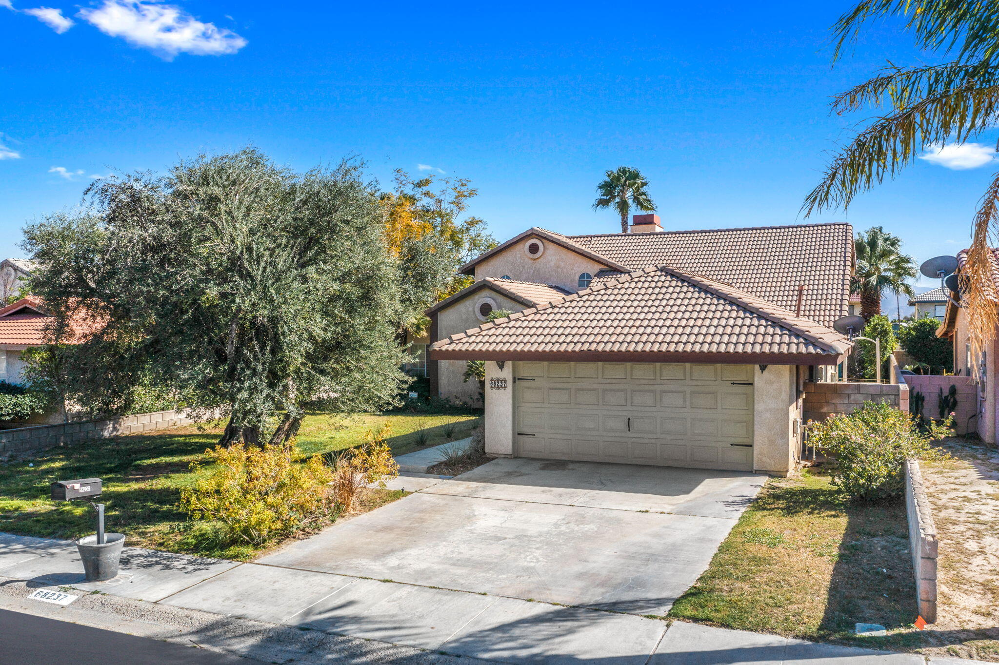 68237 Risueno Road Cathedral City, CA 92234 - Photo 1 of 34 a front view of a house with garden