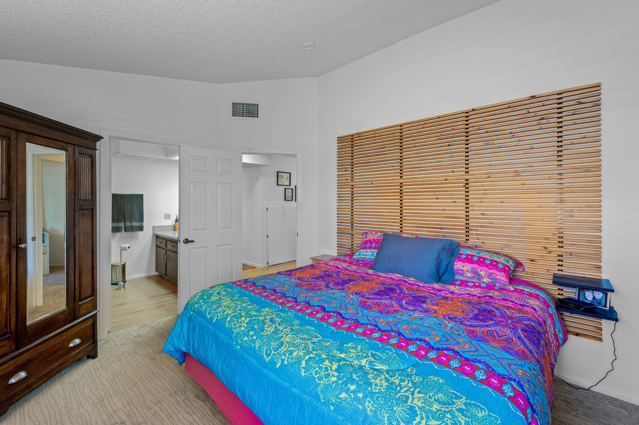 68237 Risueno Road Cathedral City, CA 92234 - Photo 15 of 34 a bedroom with a bed a dresser and mirror