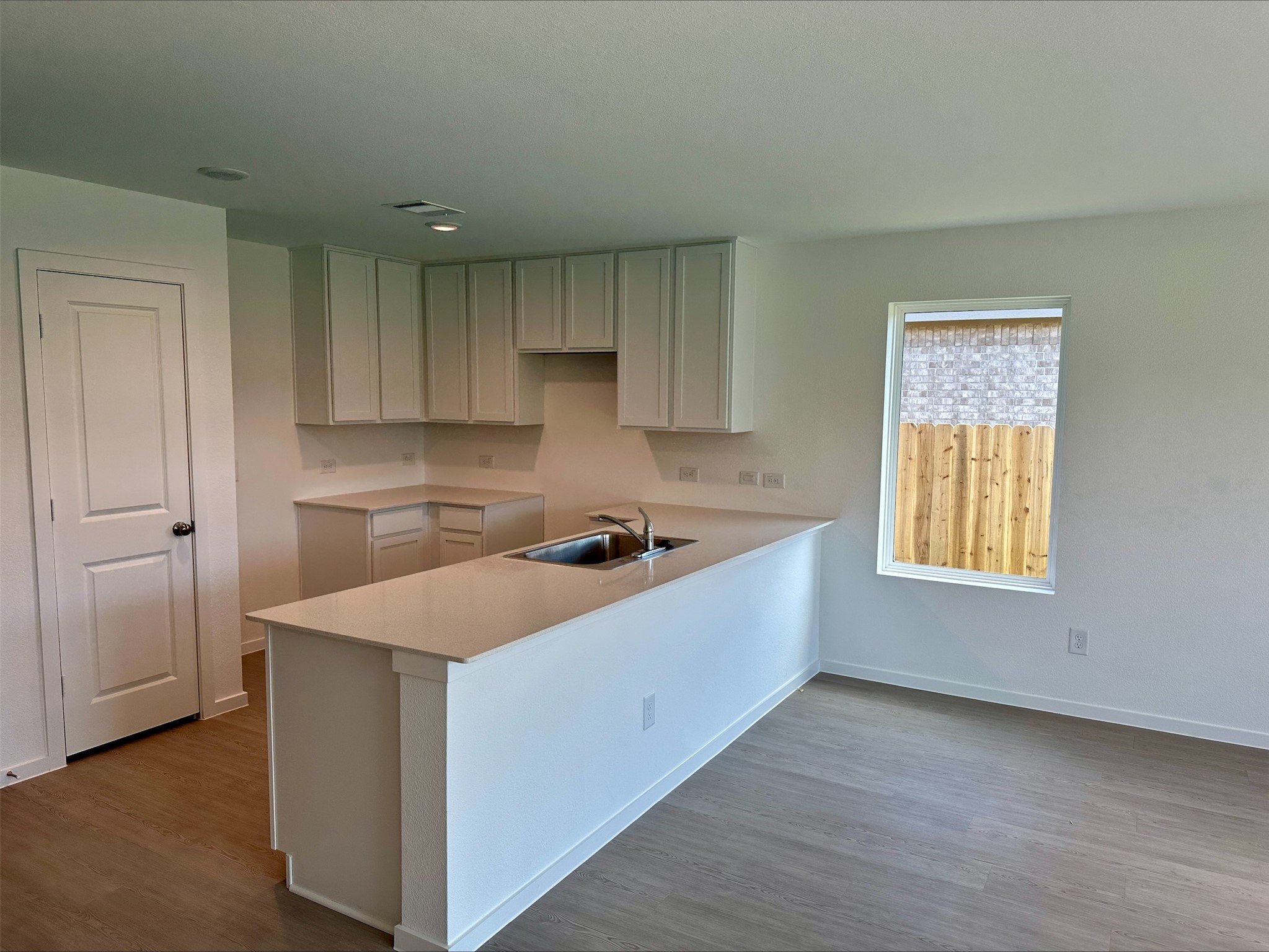 216 Amy Street Angleton, TX 77515 - Photo 13 of 36 a kitchen that has a sink in it and a window