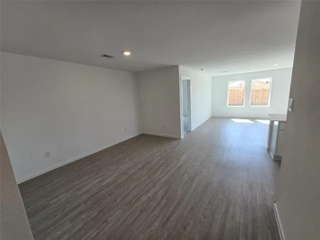 a view of a large garden with large tree and wooden fence