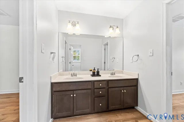 a bathroom with a double vanity sink and a mirror