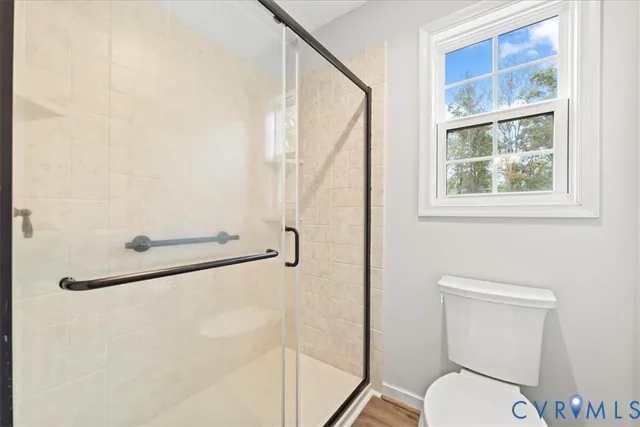 a bathroom with a toilet and a shower