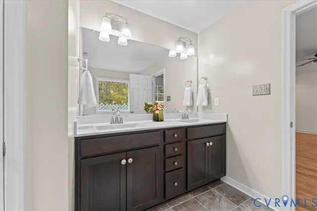 a bathroom with a double vanity sink and a mirror