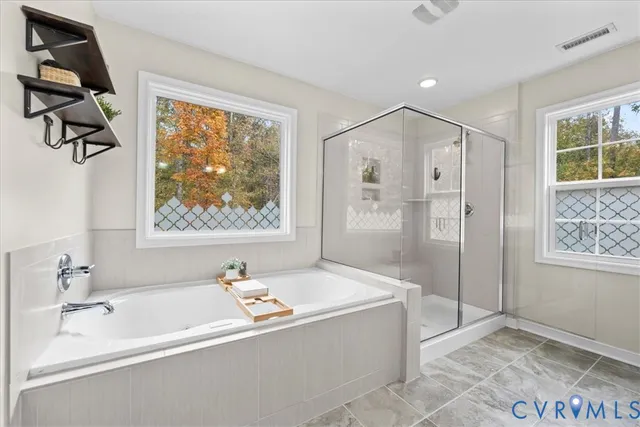 a bathroom with a tub and a shower