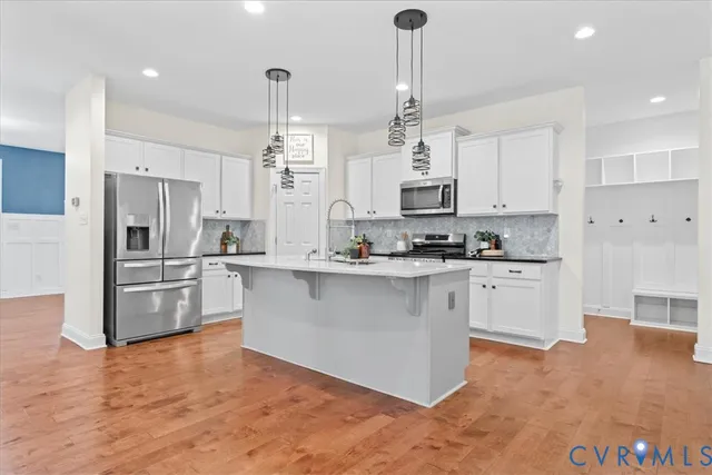 a kitchen with stainless steel appliances a refrigerator sink and microwave