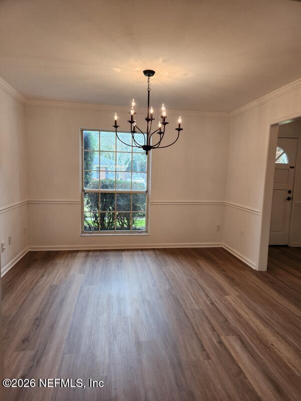 1424 Panther Run Road Jacksonville, FL 32225 - Photo 15 of 36 an empty room with wooden floor chandelier and windows