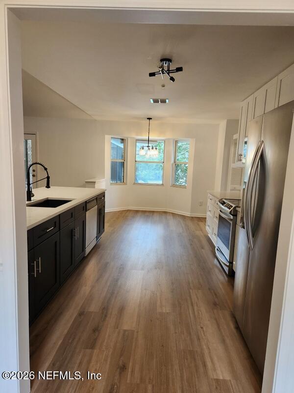 1424 Panther Run Road Jacksonville, FL 32225 - Photo 16 of 36 a kitchen with stainless steel appliances granite countertop a sink a stove a refrigerator and wooden floor