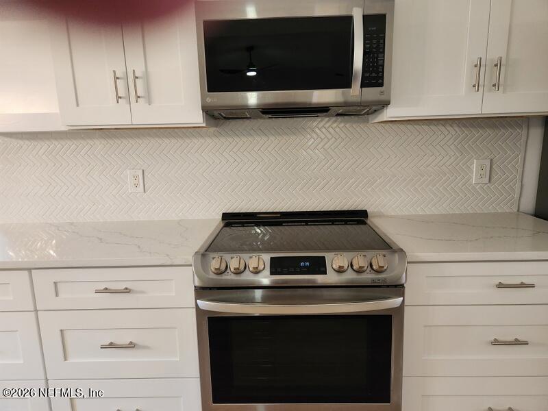 1424 Panther Run Road Jacksonville, FL 32225 - Photo 19 of 36 a stove top oven sitting inside of a kitchen