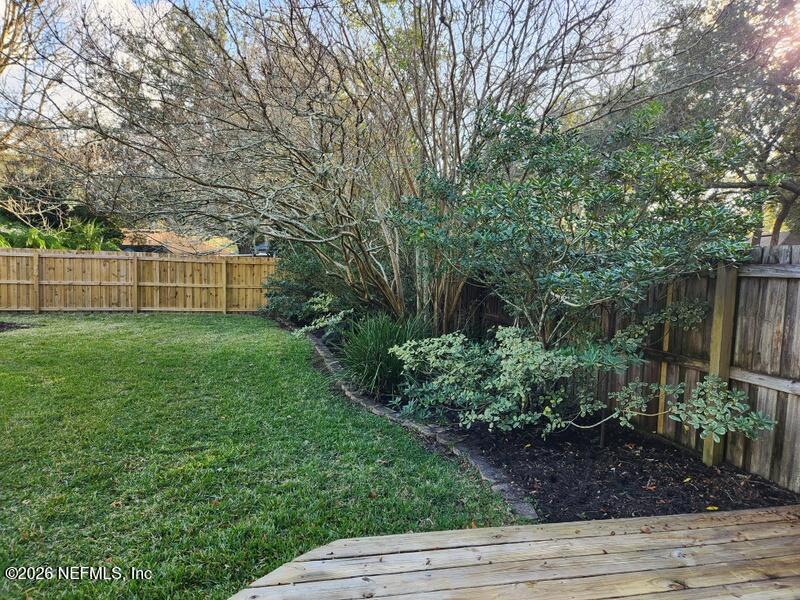 1424 Panther Run Road Jacksonville, FL 32225 - Photo 7 of 36 a view of a backyard with plants and large trees