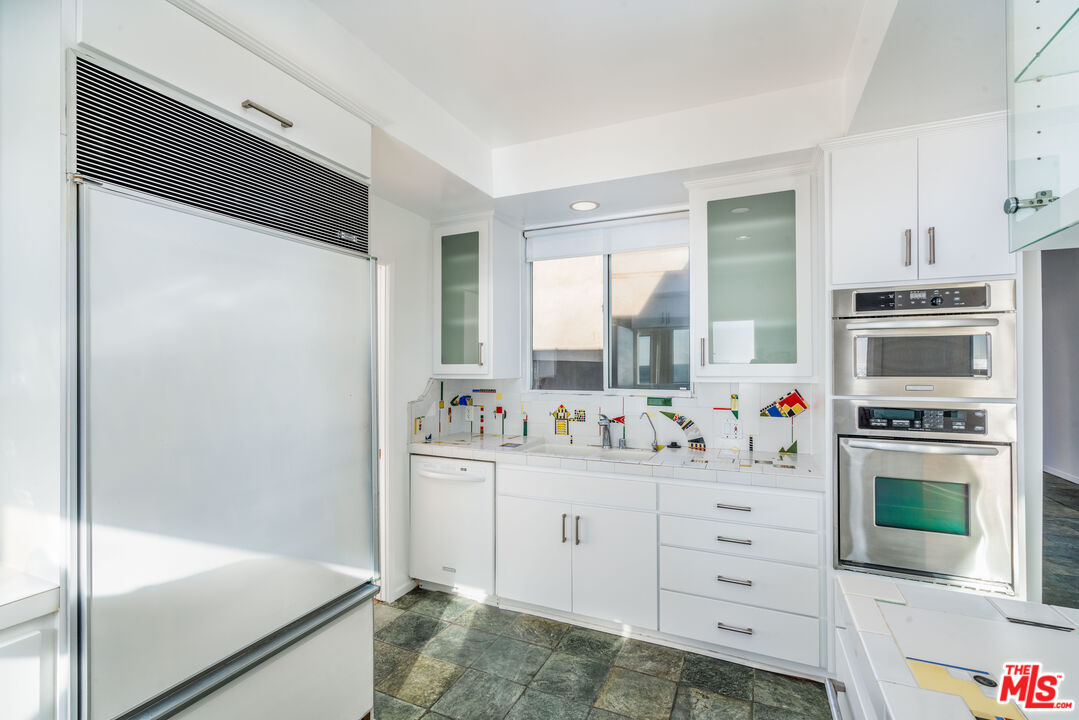 3711 Ocean Front Walk, Unit 3 Marina del Rey, CA 90292 - Photo 9 of 43 a kitchen with white cabinets and appliances