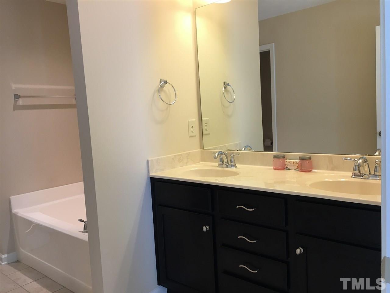 2423 Swans Rest Way Raleigh, NC 27606 - Photo 12 of 25 a bathroom with a double vanity sink and mirror