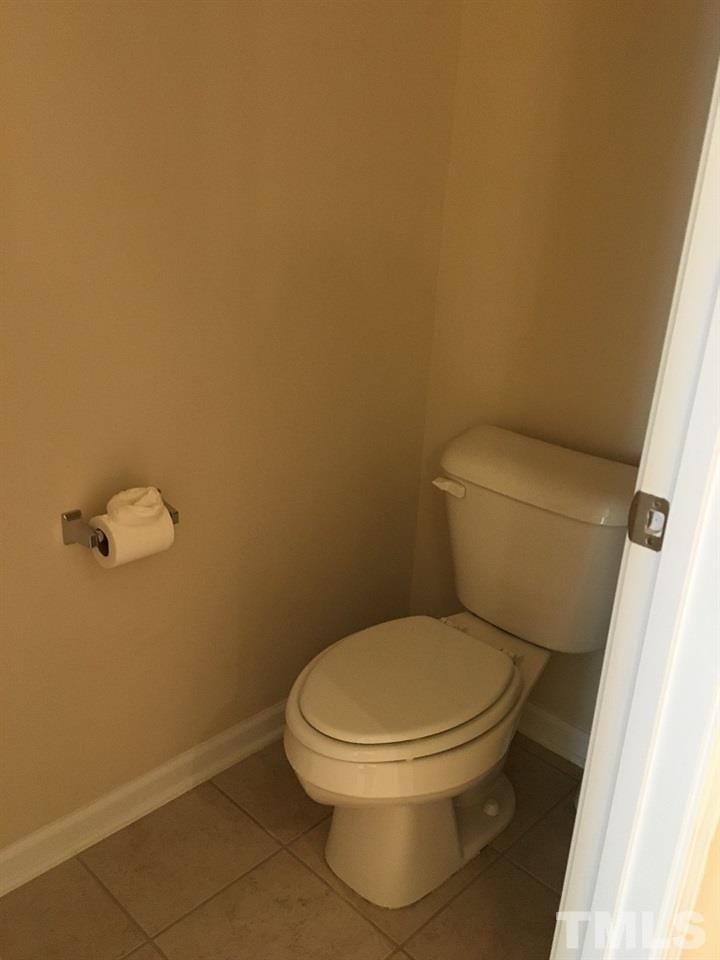 2423 Swans Rest Way Raleigh, NC 27606 - Photo 14 of 25 a white toilet sitting next to a white wall