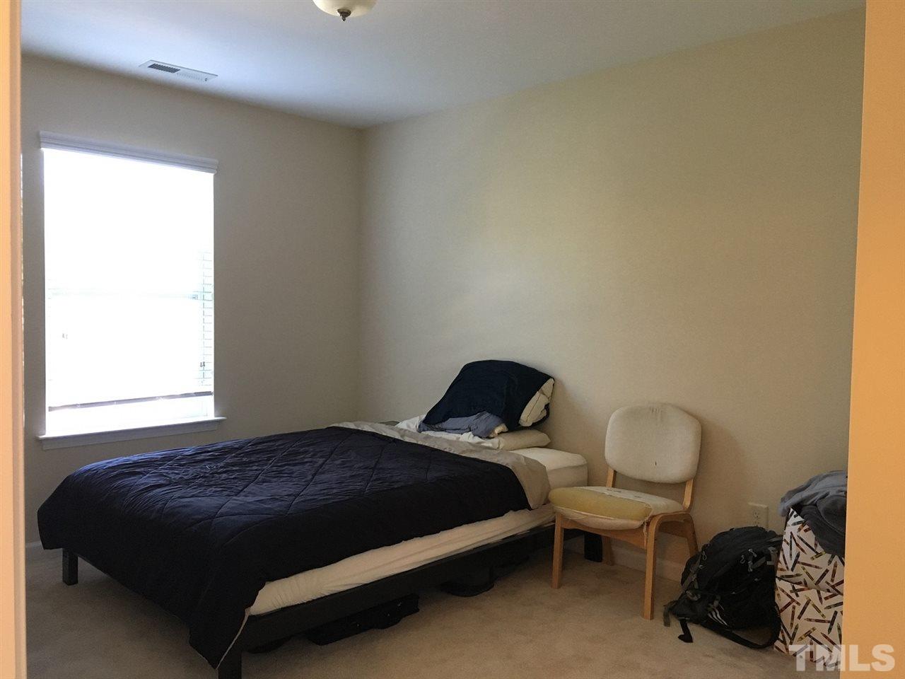 2423 Swans Rest Way Raleigh, NC 27606 - Photo 19 of 25 a bedroom with a bed and a window