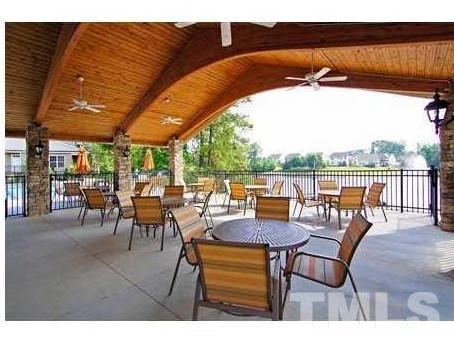 2423 Swans Rest Way Raleigh, NC 27606 - Photo 25 of 25 a view of chairs and table in patio with a lake view