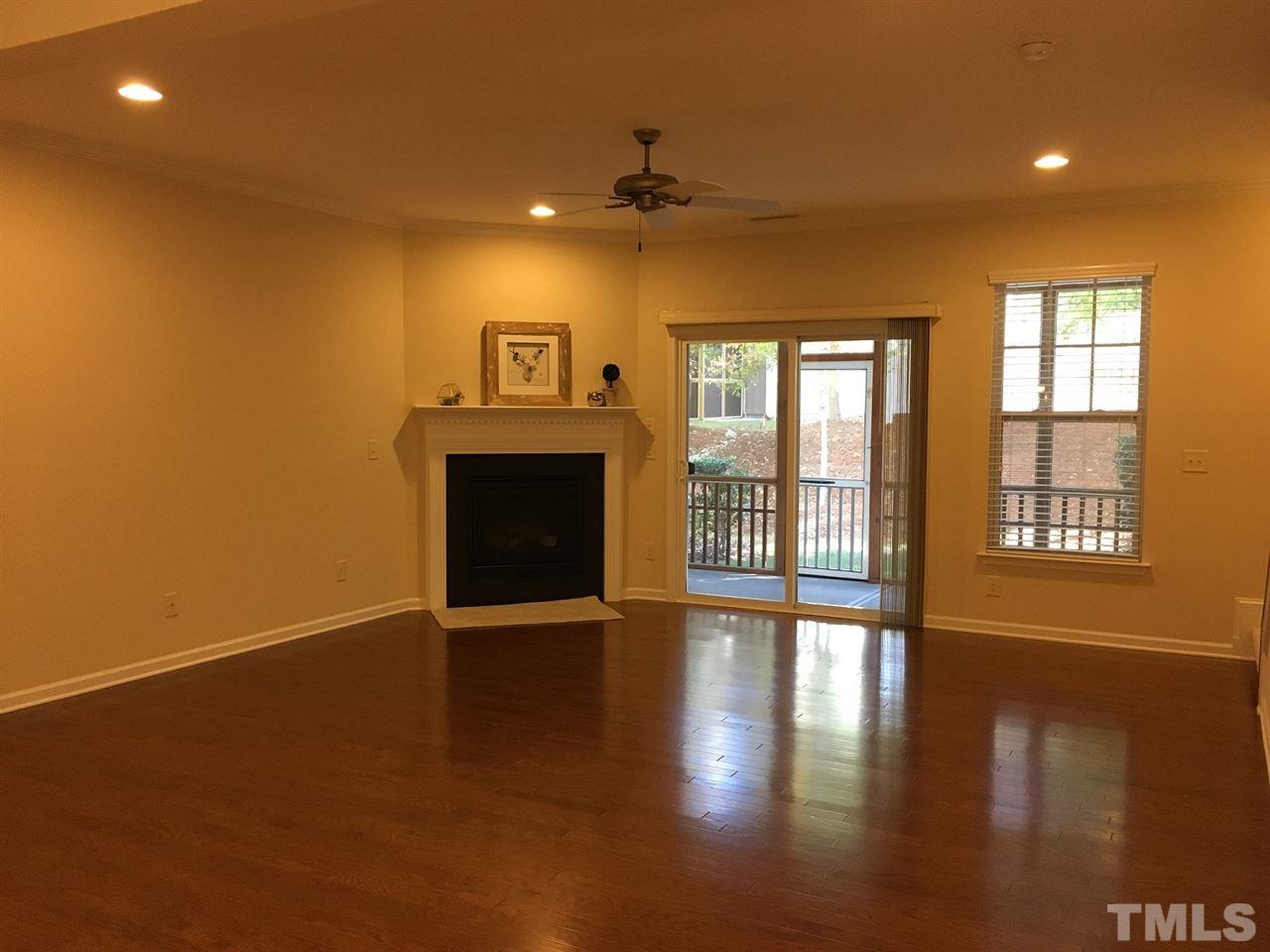 2423 Swans Rest Way Raleigh, NC 27606 - Photo 4 of 25 a view of an empty room with a fireplace and a window