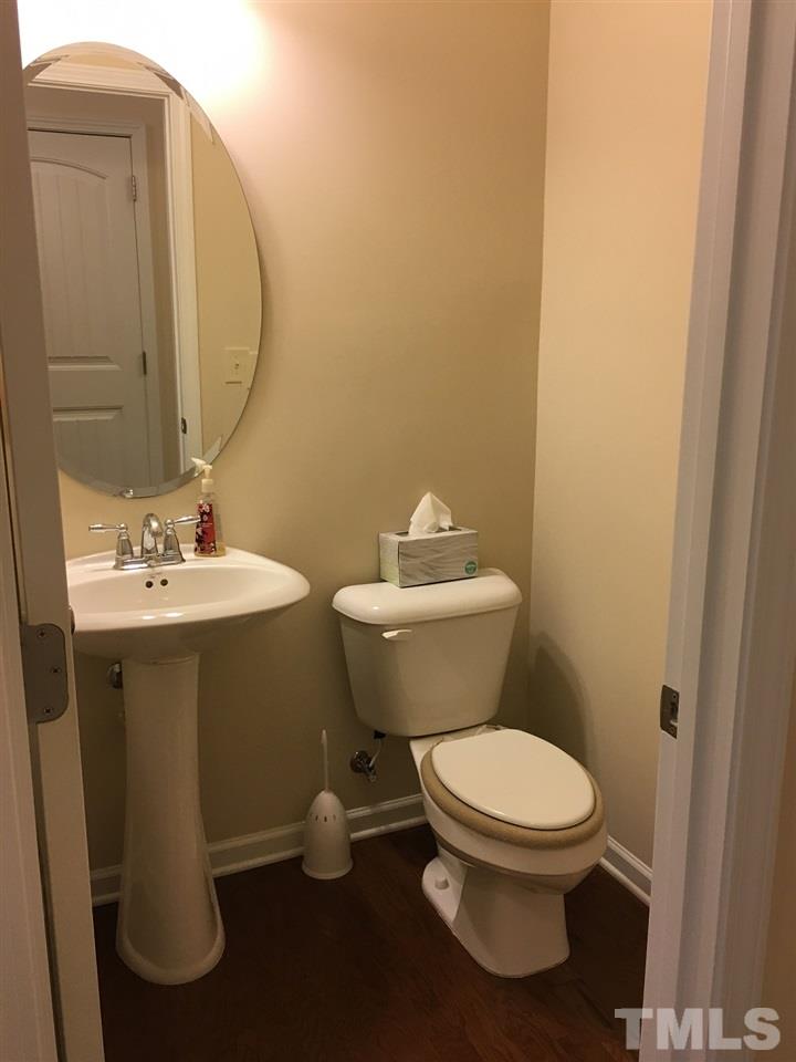 2423 Swans Rest Way Raleigh, NC 27606 - Photo 7 of 25 a bathroom with a sink toilet and a mirror