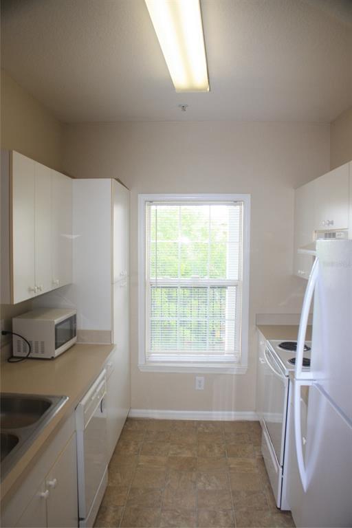 3621 Conroy Road, Unit 739 Orlando, FL 32839 - Photo 9 of 20 a kitchen with a sink and a window
