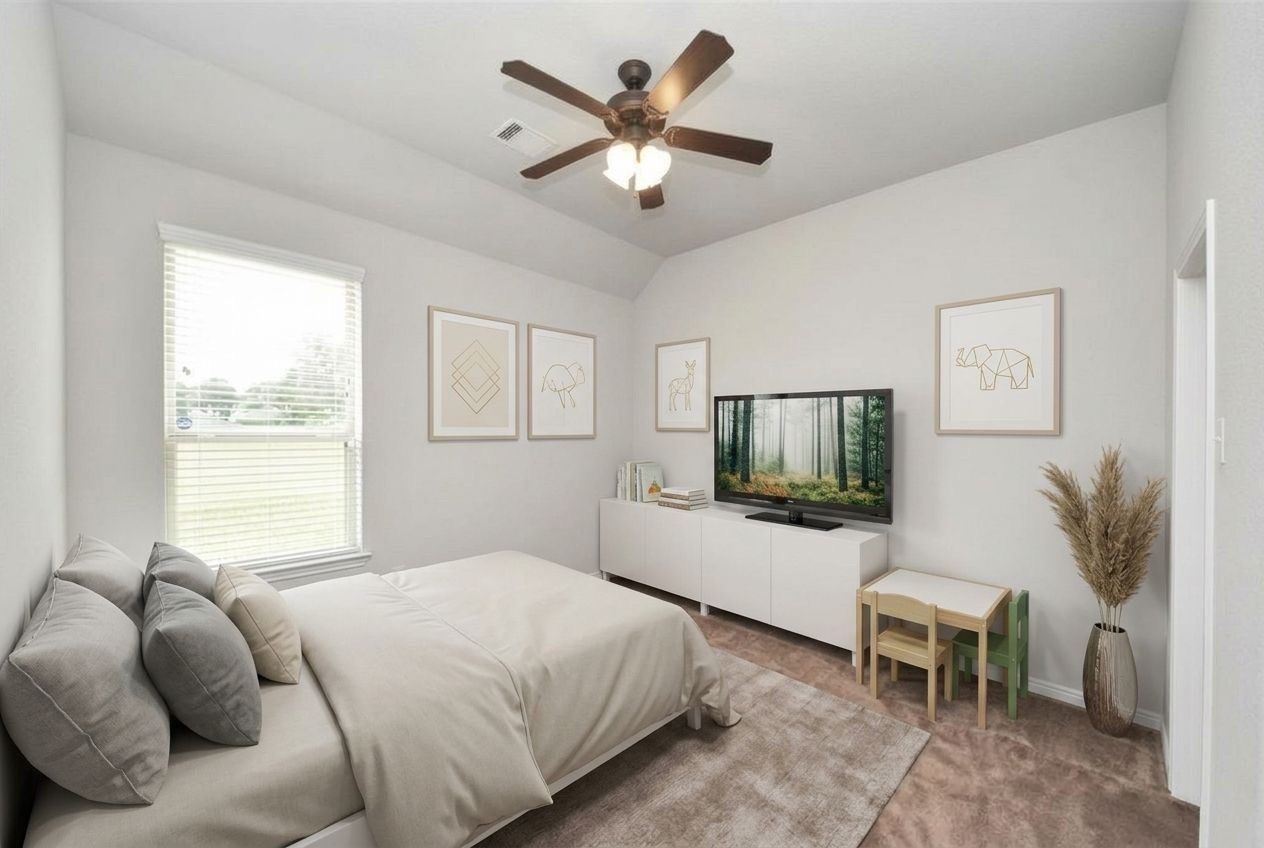 24503 Eucalyptus Way Spring, TX 77373 - Photo 11 of 27 a bedroom with a bed and a flat screen tv